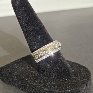 Silver band with 7 beautiful cz stone with an infinity design size 7..25044